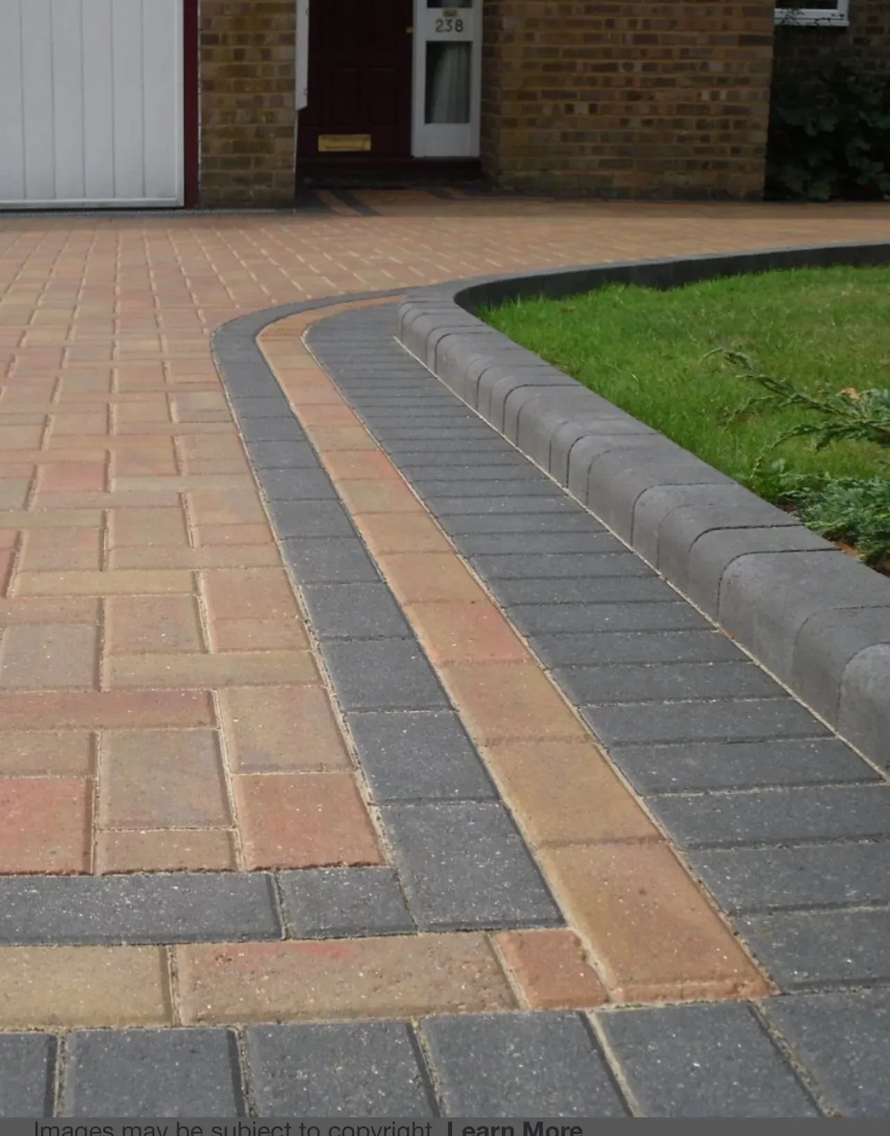High quality block paving driveway with decorative charcoal borders and raised kerb stone edging